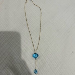 Gold necklace with blue beading drop detail